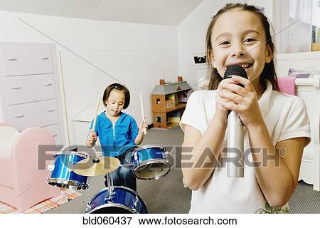 Asian sisters playing drums and singing View Large Photo Image Stock Photo - Asian sisters playing drums and singing. Fotosearch