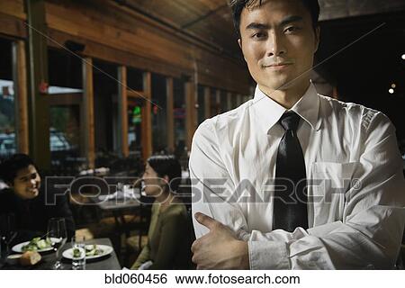 Asian waiter with arms crossed View Large Photo Image Stock Photograph - Asian waiter with arms crossed. Fotosearch