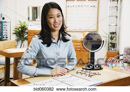 Stock Image - Asian woman at optometrist’s office. Fotosearch