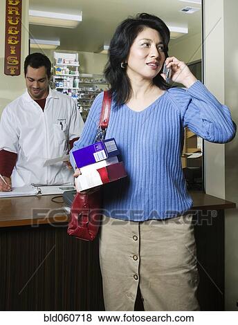 Stock Photo - Asian woman talking on cell phone. Fotosearch