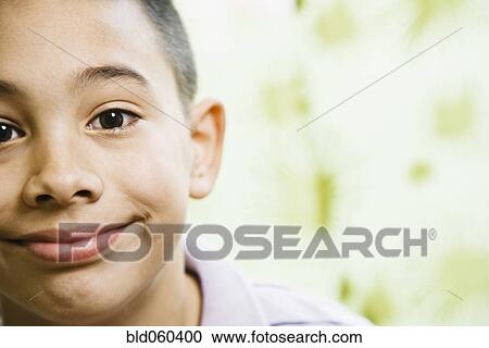Stock Image - Close up of Asian boy smiling. Fotosearch