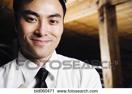 Stock Image - Close up of Asian man smiling. Fotosearch