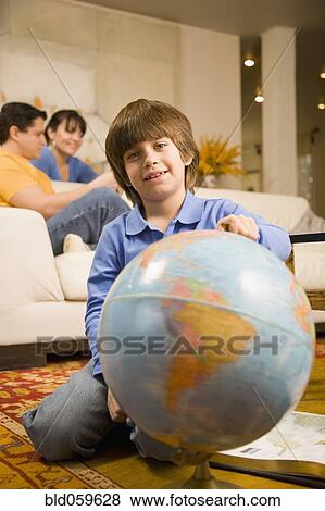 Hispanic boy holding globe View Large Photo Image Stock Photo - Hispanic boy holding globe. Fotosearch