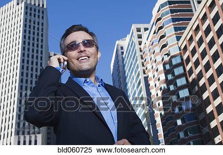 Hispanic businessman talking on cell phone View Large Photo Image Stock Photography - Hispanic businessman talking on cell phone. Fotosearch