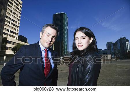 Hispanic businesspeople in front of high-rises View Large Photo Image Stock Photo - Hispanic businesspeople in front of high-rises. Fotosearch