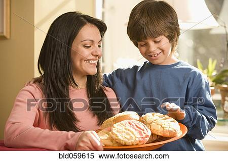 Hispanic mother and son holding plate of cookies View Large Photo Image Stock Photography - Hispanic mother and son holding plate of cookies. Fotosearch
