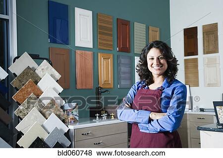 Stock Photo - Hispanic sales clerk in home decor store. Fotosearch