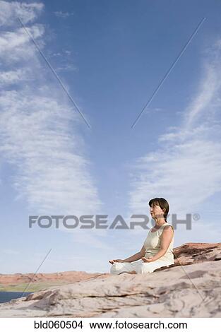 Picture - Hispanic senior woman meditating. Fotosearch