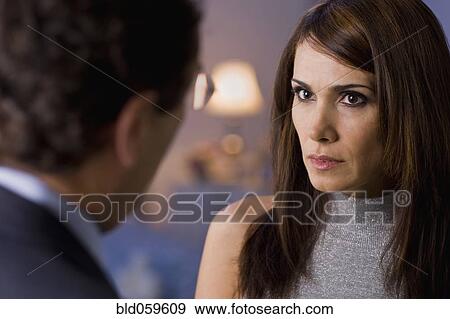 Stock Photo - Hispanic woman looking at husband. Fotosearch