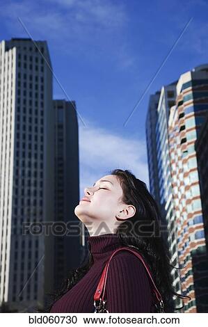 Hispanic woman with head tilted up View Large Photo Image Stock Image - Hispanic woman with head tilted up. Fotosearch