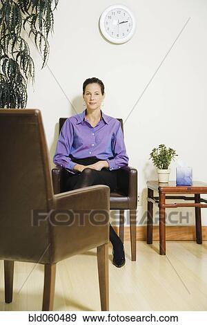 Mixed Race businesswoman sitting in waiting area View Large Photo Image Stock Photo - Mixed Race businesswoman sitting in waiting area. Fotosearch