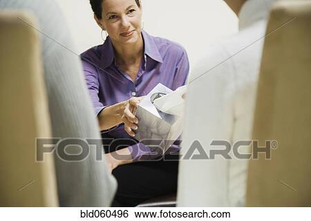 Mixed Race woman handing tissue box to man View Large Photo Image Stock Photograph - Mixed Race woman handing tissue box to man. Fotosearch