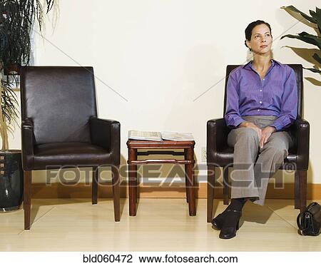Mixed Race woman sitting in waiting area View Large Photo Image Stock Image - Mixed Race woman sitting in waiting area. Fotosearch