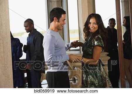 Multi-ethnic couple dancing at party View Large Photo Image Stock Photo - Multi-ethnic couple dancing at party . Fotosearch
