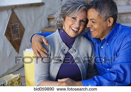 Stock Image - Multi-ethnic couple hugging. Fotosearch
