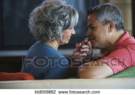 Multi-ethnic couple smiling at each other View Large Photo Image Stock Image - Multi-ethnic couple smiling at each other. Fotosearch