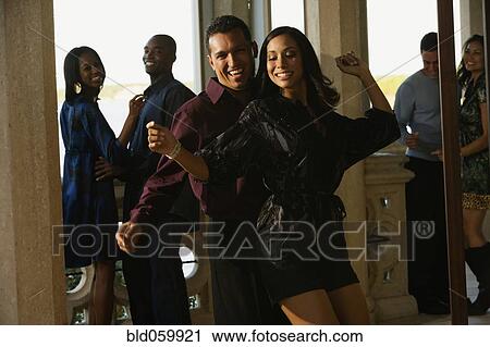 Multi-ethnic couples dancing at party View Large Photo Image Stock Image - Multi-ethnic couples dancing at party . Fotosearch