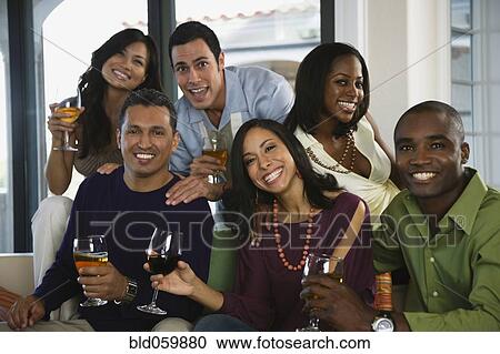 Stock Image - Multi-ethnic friends at party. Fotosearch