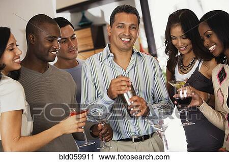 Stock Image - Multi-ethnic friends at party. Fotosearch