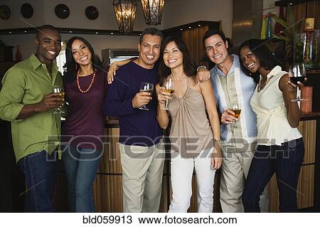 Stock Image - Multi-ethnic friends at party. Fotosearch