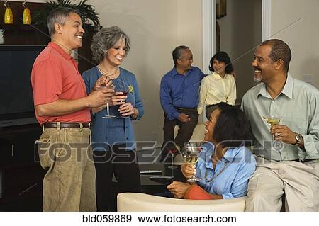 Stock Photo - Multi-ethnic friends at party. Fotosearch