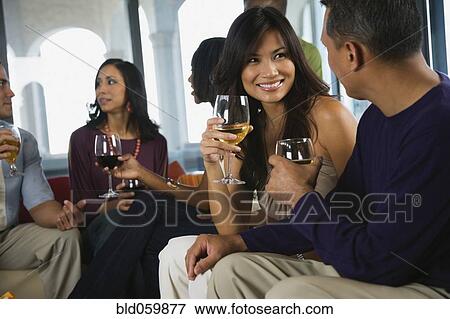 Stock Photo - Multi-ethnic friends at party. Fotosearch