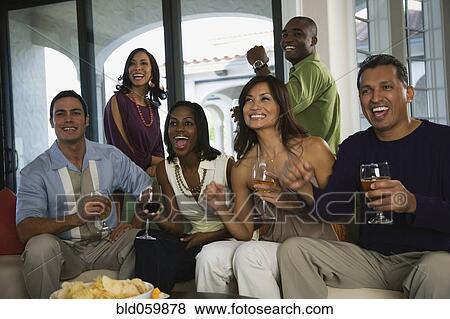 Stock Photo - Multi-ethnic friends at party. Fotosearch