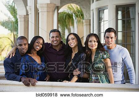 Multi-ethnic friends on balcony View Large Photo Image Stock Photo - Multi-ethnic friends on balcony. Fotosearch