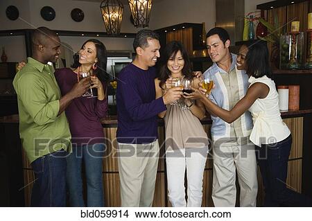 Multi-ethnic friends toasting at party View Large Photo Image Picture - Multi-ethnic friends toasting at party. Fotosearch
