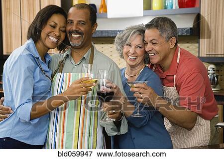 Stock Photo - Multi-ethnic friends toasting with wine. Fotosearch
