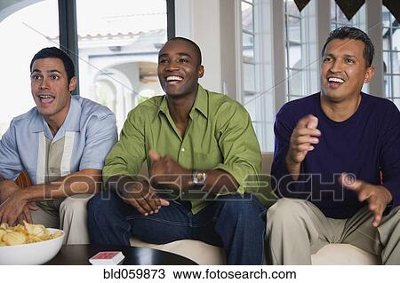 Multi-ethnic men sitting on sofa View Large Photo Image Stock Image - Multi-ethnic men sitting on sofa. Fotosearch