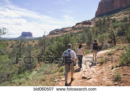Multi-ethnic people hiking in desert View Large Photo Image Stock Photo - Multi-ethnic people hiking in desert. Fotosearch