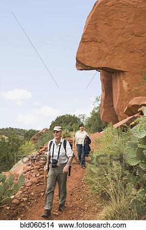 Picture - Multi-ethnic senior couple hiking in desert. Fotosearch