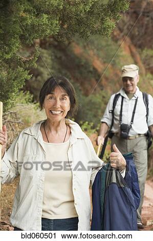 Stock Image - Multi-ethnic senior couple hiking. Fotosearch