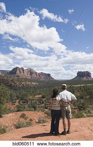 Stock Image - Multi-ethnic senior couple looking at desert landscape. Fotosearch
