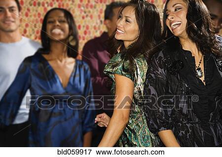 Multi-ethnic women dancing at party View Large Photo Image Stock Photo - Multi-ethnic women dancing at party. Fotosearch