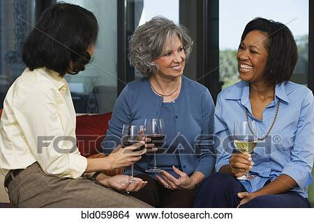 Picture - Multi-ethnic women drinking wine. Fotosearch