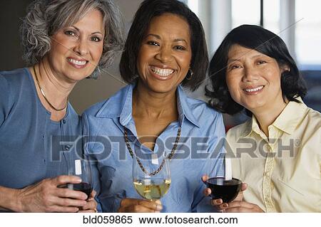 Stock Photography - Multi-ethnic women drinking wine. Fotosearch
