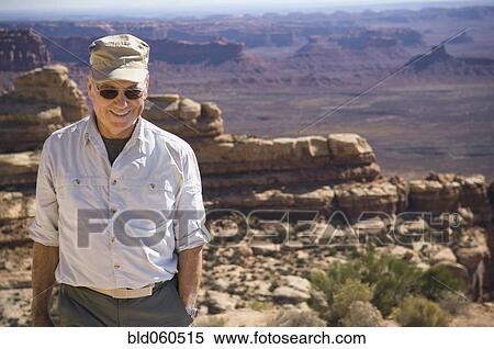 Stock Photography - Senior man in front of desert landscape. Fotosearch