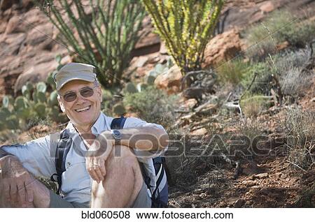 Senior man sitting on ground View Large Photo Image Stock Photo - Senior man sitting on ground. Fotosearch