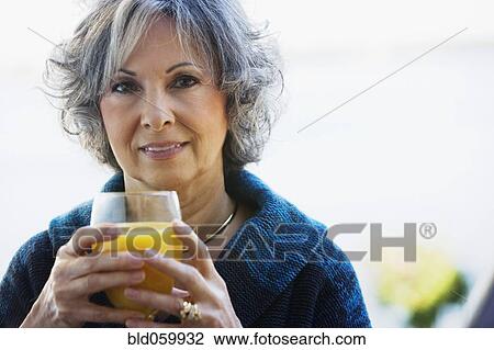 Woman drinking orange juice View Large Photo Image Stock Image - Woman drinking orange juice. Fotosearch