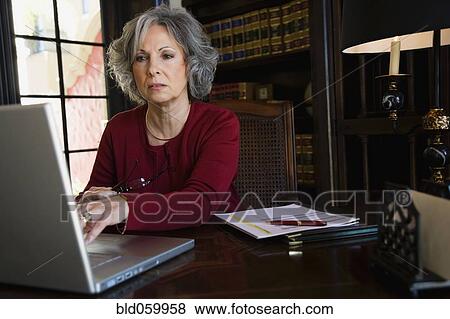 Stock Photo - Woman typing on laptop. Fotosearch
