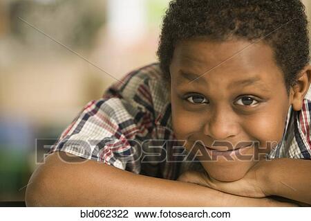 African boy laying head on arms View Large Photo Image Stock Image - African boy laying head on arms. Fotosearch