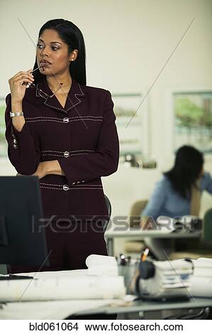 Picture - African businesswoman thinking. Fotosearch
