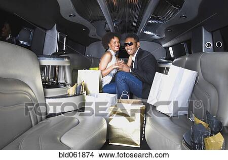 African couple with shopping bags in limousine View Large Photo Image Picture - African couple with shopping bags in limousine. Fotosearch