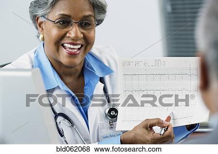 African female doctor explaining electrocardiogram to patient View Large Photo Image Stock Photo - African female doctor explaining electrocardiogram to patient. Fotosearch