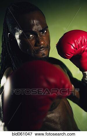 Stock Photo - African male boxer punching. Fotosearch