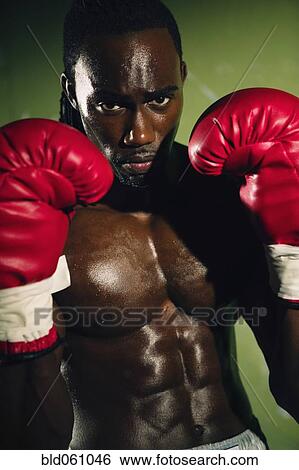 Stock Photograph - African male boxer wearing gloves. Fotosearch