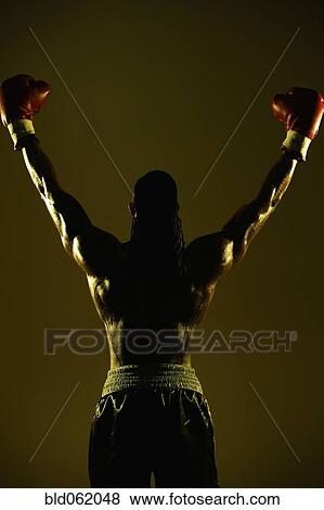 Stock Photo - African male boxer with arms raised. Fotosearch
