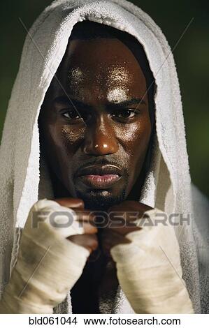 Picture - African male boxer with towel on head. Fotosearch
